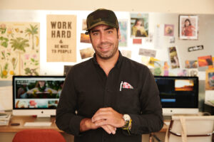 Jason Cutinella, Founder and CEO of NMG Network, standing in his office.