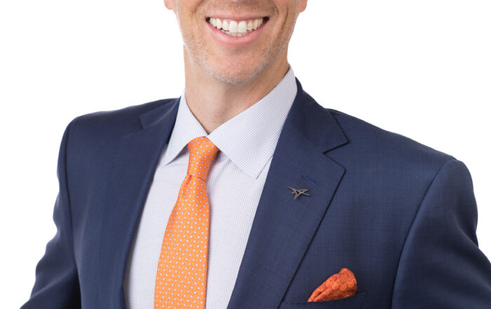 Professional guest in a blue suit appearing on The Covert Code Podcast with Adam Witty to explore publishing strategies, brand authority, and business growth.