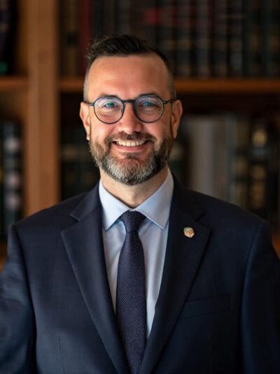 Dennis Meador featured guest on The Covert Code Podcast, professional portrait of CEO and founder of The Legal Podcast Network discussing podcasting, authority building, and personal branding